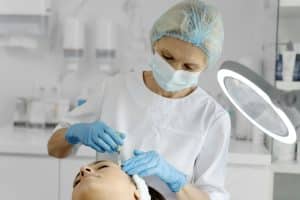 Cosmetologist does prp therapy on the face of a beautiful woman in a beauty salon